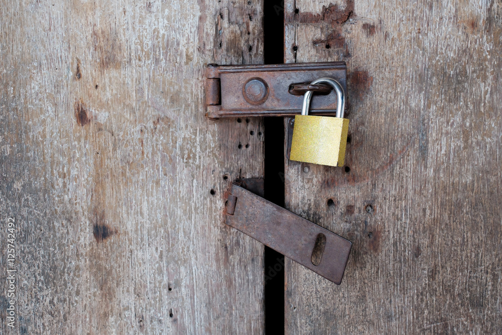 Old rusty padlock on old wooden door. Old rusty padlock on old wooden door.