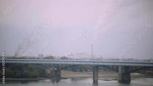 Bridge over the river in a gray cloudy day on dirty city. 1920x1080 photo