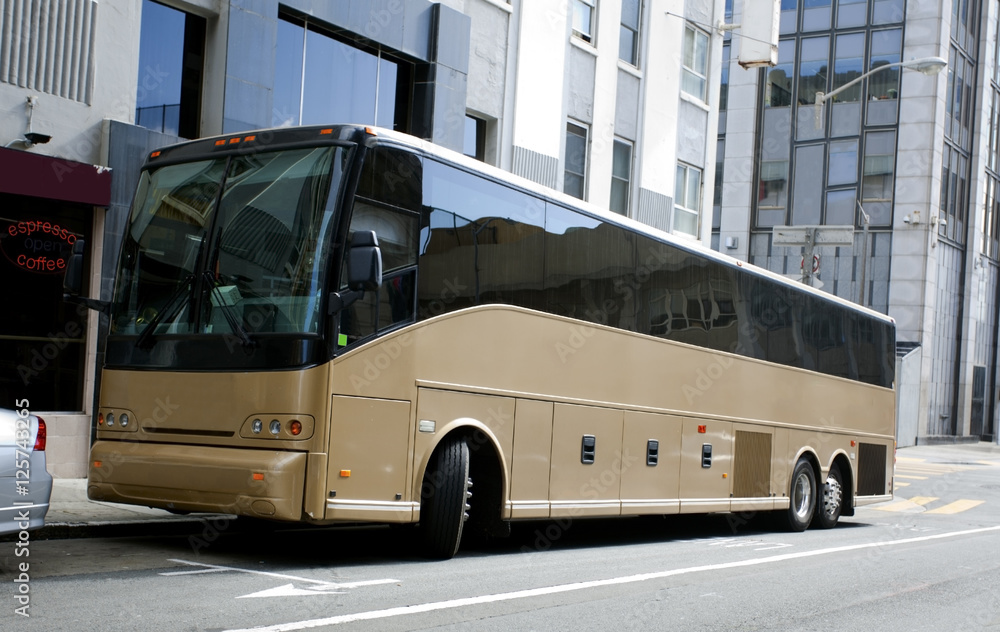 Rear Side View of Gold Charter Bus
