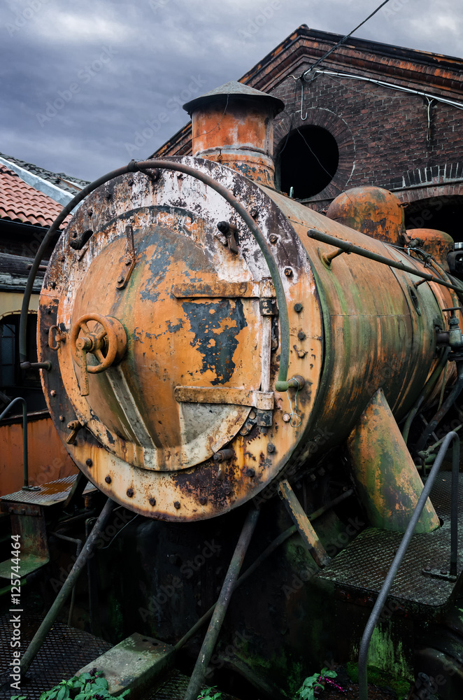 Rusty steam locomotive in the station of Turin Ponte Mosca (Italy), repair workshop for old trains