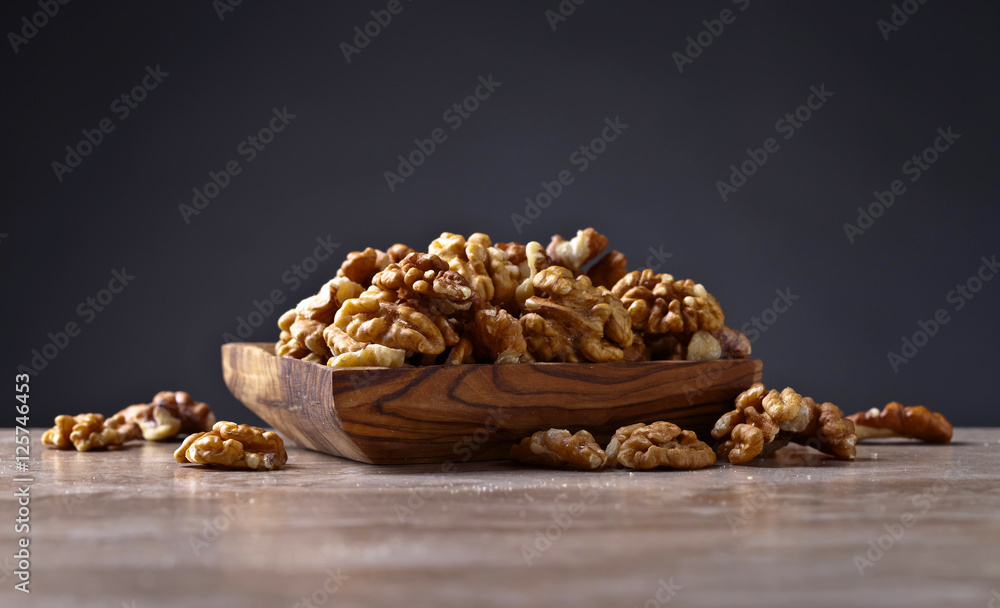 Obraz premium Walnuts in old wooden dish