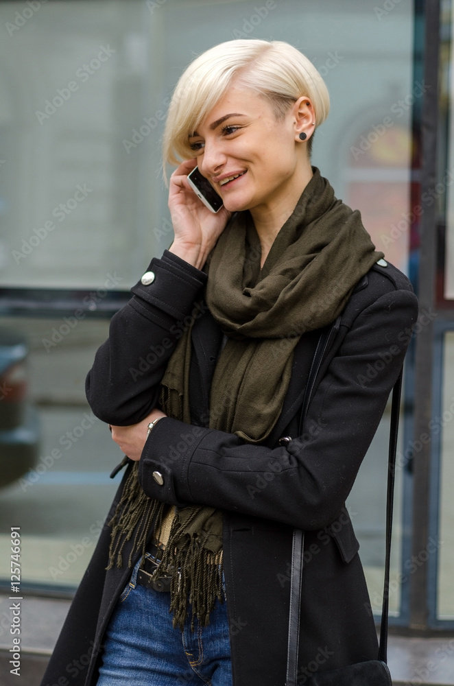 Fototapeta premium Young girl using her phone