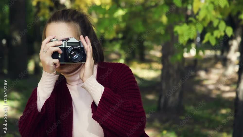 Girl makes a photo on the old camera. Photoshoot fall. Girl makes a photo on the old camera. Photoshoot fall.