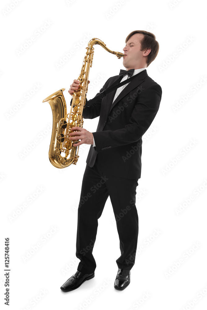 Fototapeta premium Saxophonist in a tuxedo plays music on sax.