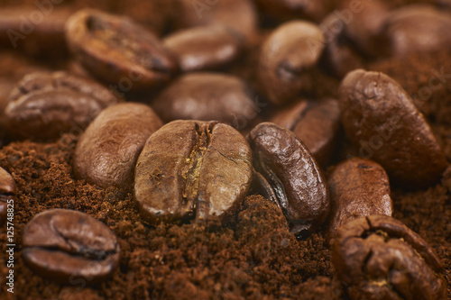 Close Up Of Coffee Beans Over Grained Coffee