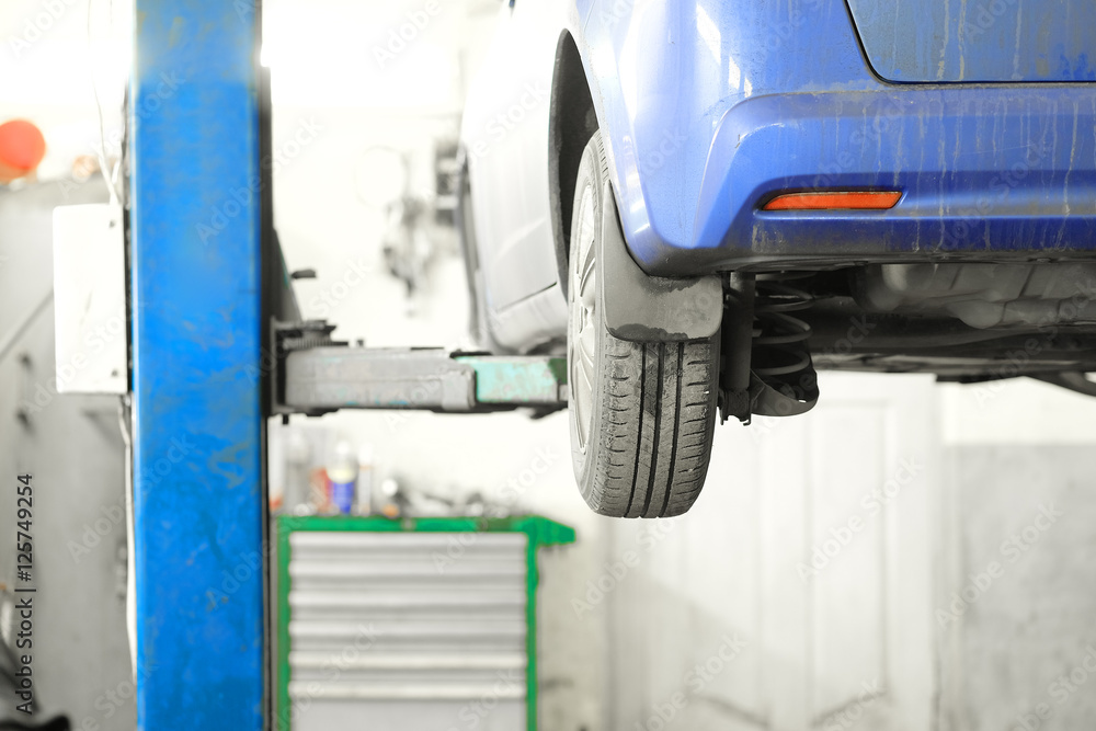 Fototapeta premium Car under repair in a car repair station