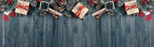 Christmas background with spruce, gift box, Santa Claus boots an