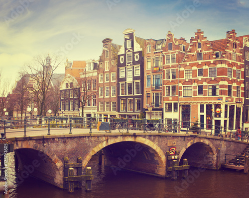 Prinsengracht Canal, Amsterdam, The Netherlands. Typical Dutch houses with a crow-stepped gable behind the bridge. Toned image.