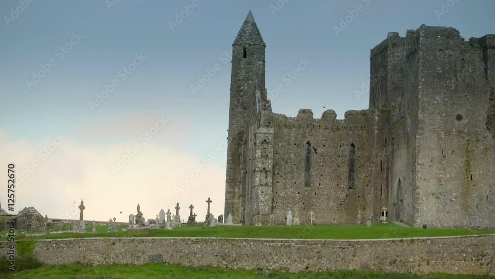 Outside the Rock of Cashel in Ireland with few birds flying outside on a blue sky Outside the Rock of Cashel in Ireland with few birds flying outside on a blue sky