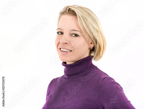 Shot of a blonde woman lying and smiling in front of a white background