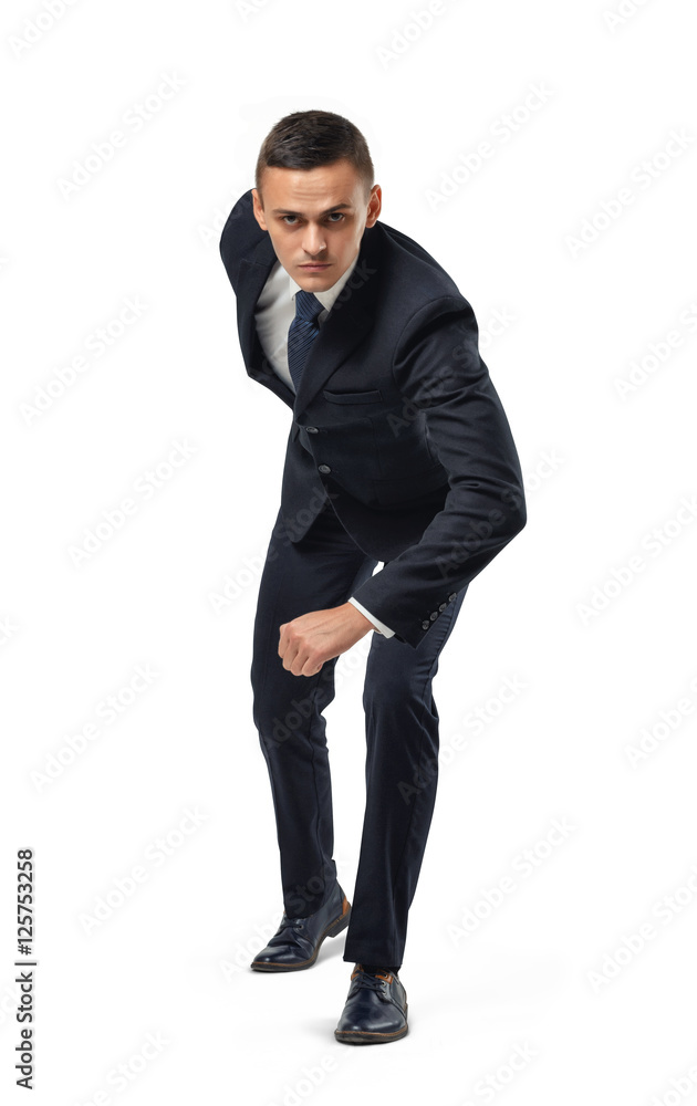 Businessman in posture of readiness before the start isolated on white background. Businessman in posture of readiness before the start isolated on white background.