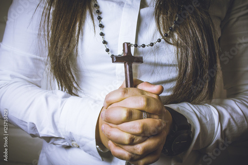 Beautiful  woman with hopeful holding christian symbol of crucif photo