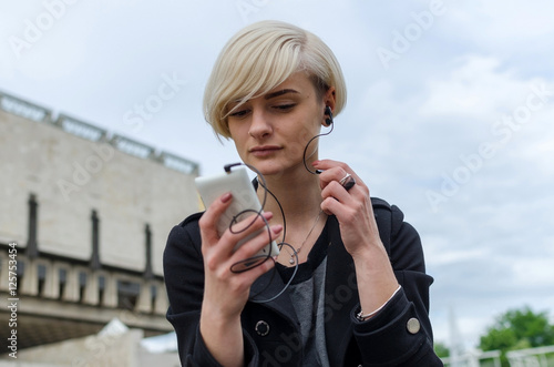 Young blonde woman listning to music