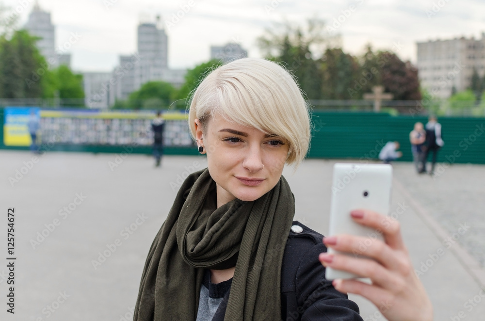 Fototapeta premium Young girl makes selfie