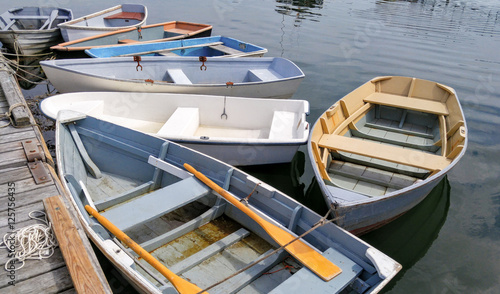 Small Boats at a Dock:  Several rowboats tied to a wooden pier sit quietly on bay in Maine.
 photo