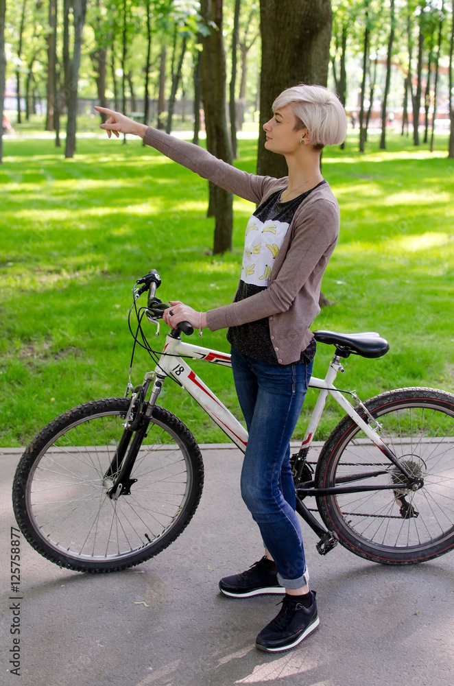 Fototapeta premium Young girl with a bicycle