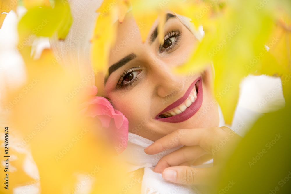 Beutiful Girl among the leaves with a beautiful smile Beutiful Girl among the leaves with a beautiful smile