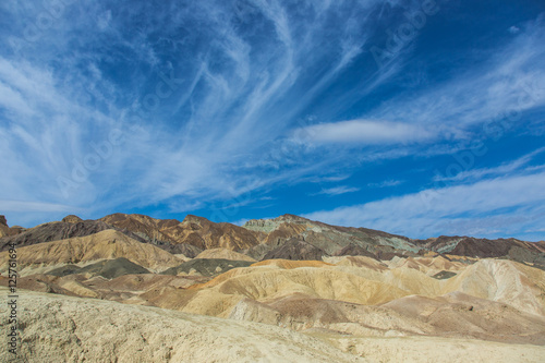 Blue sky over painted desert hills