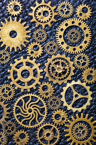 steampunk mechanical cogs gears wheels on leather background