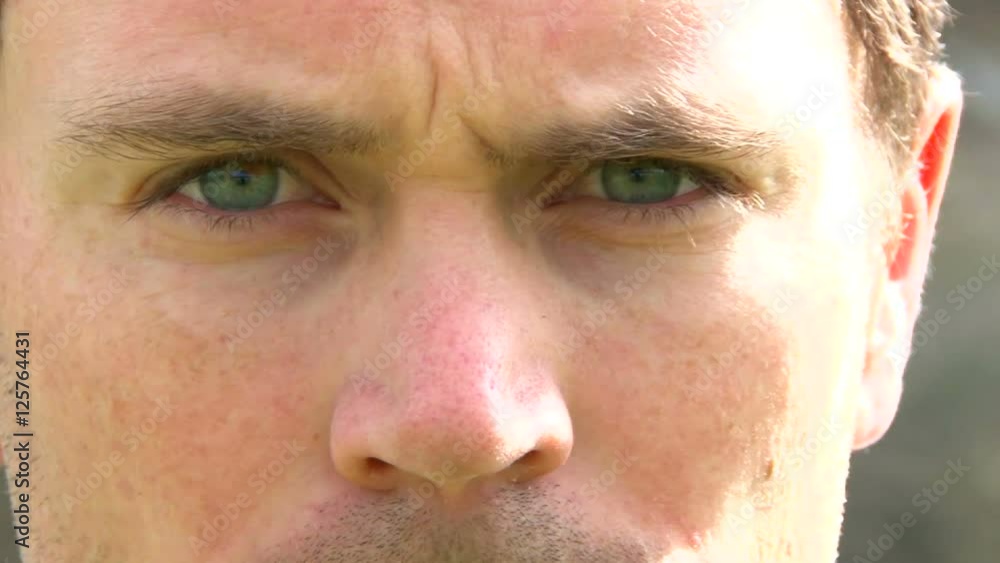 Angry man appears, stares down camera and moves out of frame. Angry man appears, stares down camera and moves out of frame.