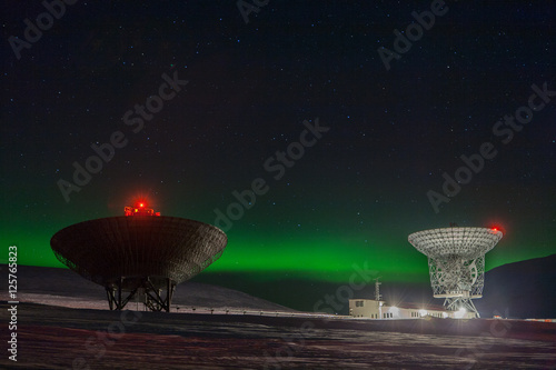 Nothern lights and research antennas outside Longyearbyen photo