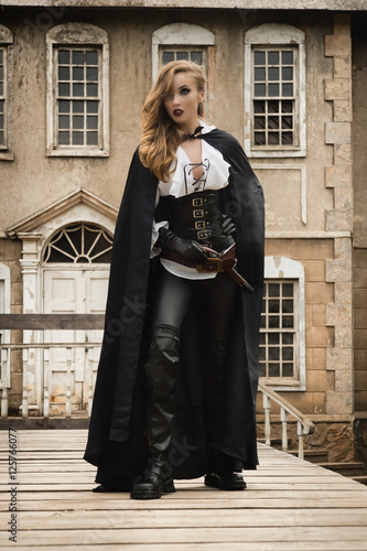 Sexy woman in pirate style with old handgun