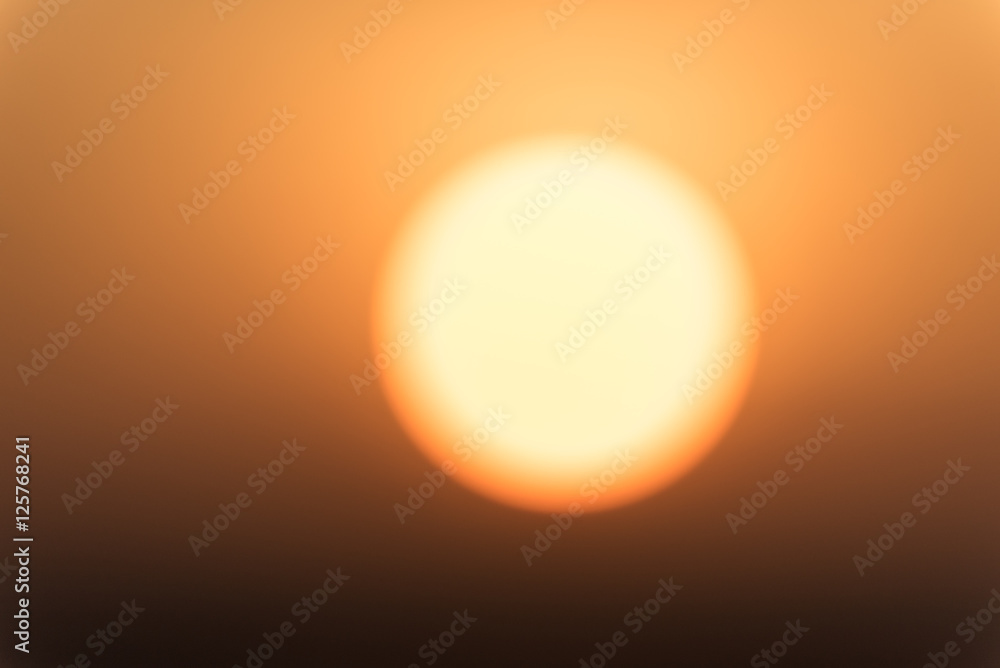 Defocused closeup shot on the sun during sunrise Defocused closeup shot on the sun during sunrise