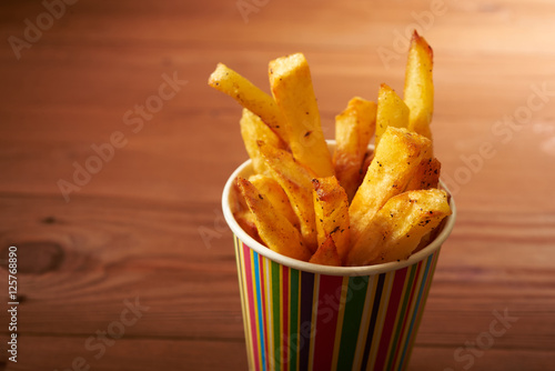 fried French fries close up in paper cup