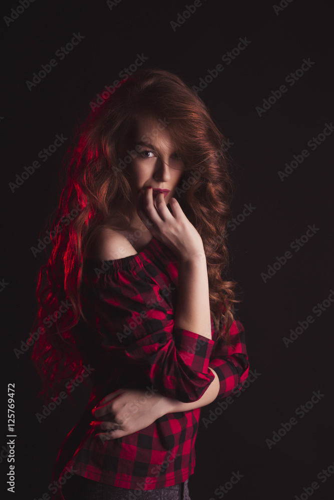 Model with shadow on her face and red light