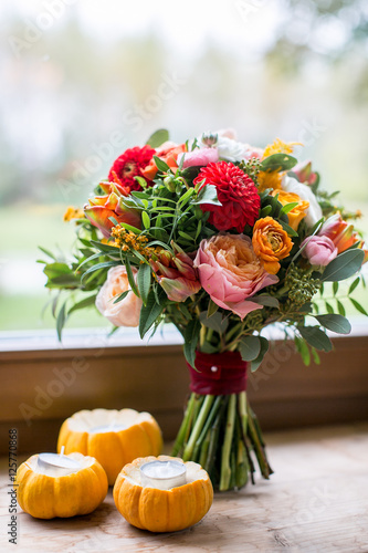 Window sill decorated with pumpkins and a flowerpot