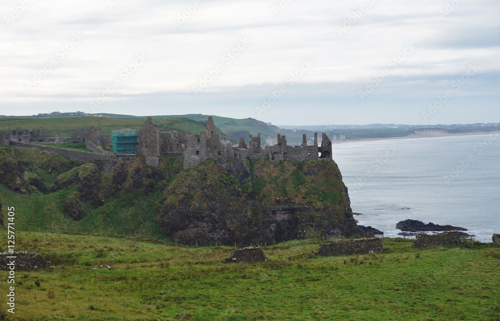 Ruins of the medieval Dunluce Castle on a cliff in Northern Ireland