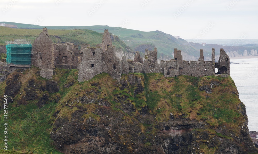 Ruins of the medieval Dunluce Castle on a cliff in Northern Ireland