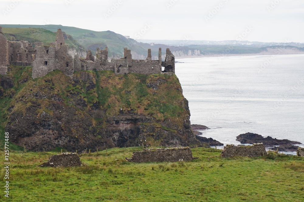 Ruins of the medieval Dunluce Castle on a cliff in Northern Ireland