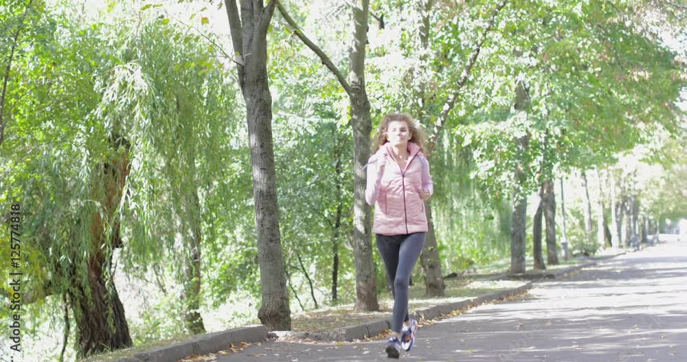 Woman run park young active fitness female runner exercising outdoor sport girl jogging morning autumn forest slow motion 60 fps