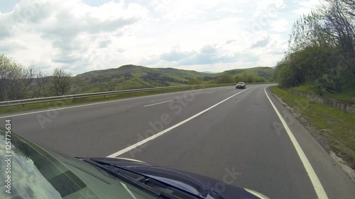 Driving on the highway in the mountains. Point of view camera filming.