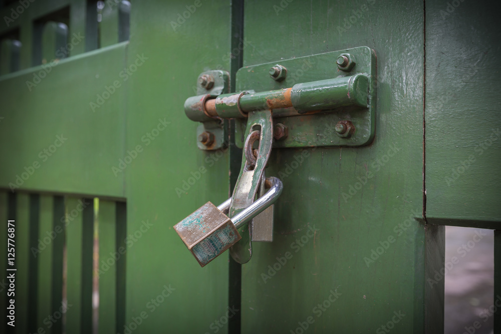 Selective focus of Lock on the gate, shadow vintage or retro style Selective focus of Lock on the gate, shadow vintage or retro style