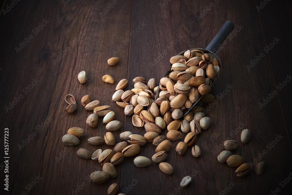 Pistachios over dark background. Food background with copyspace. Studio photography. Object shooting. Pistachios over dark background. Food background with copyspace. Studio photography. Object shooting.