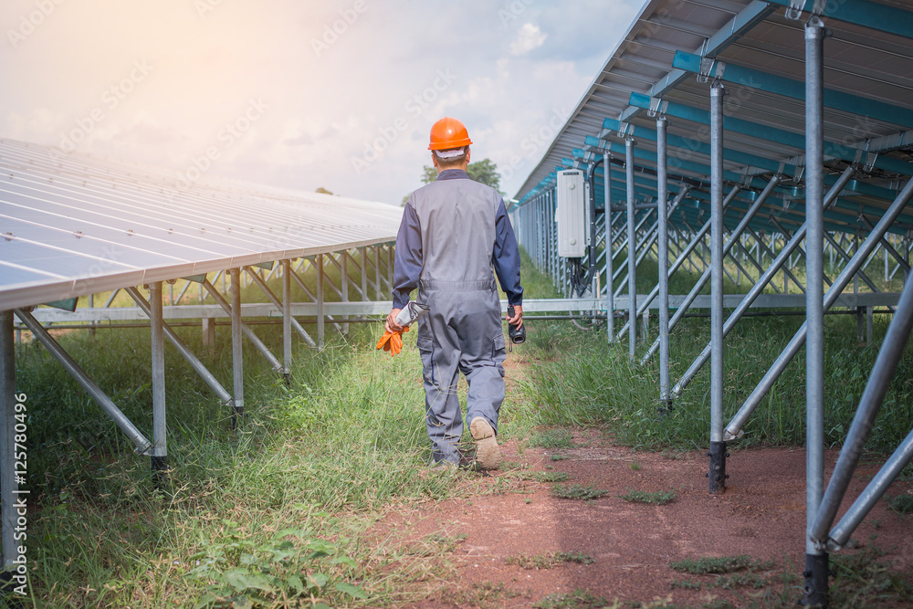 an engineer working on checking equipment in solar power plant an engineer working on checking equipment in solar power plant