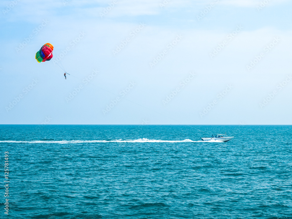 Parasailing against a blue sky and cloud Parasailing against a blue sky and cloud