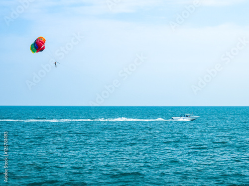 Parasailing against a blue sky and cloud
