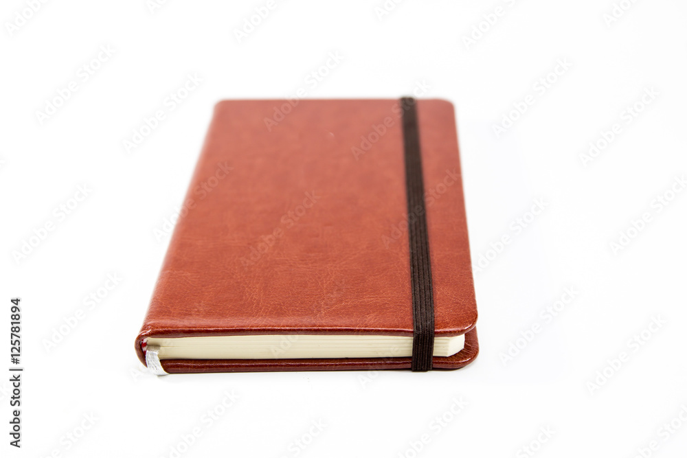 Small brown notebook isolated in white background. Small brown notebook isolated in white background.