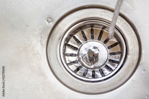 Dirty stainless steel sink close up.