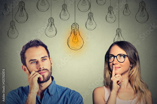 Cognitive skills male vs female. Man and woman looking at light bulb photo