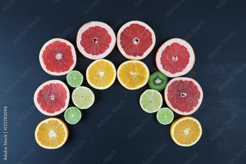 Creative arrangement of citrus fruit slices on blackboard looking like open mouth. Horizontal image with copy space Creative arrangement of citrus fruit slices on blackboard looking like open mouth. Horizontal image with copy space
