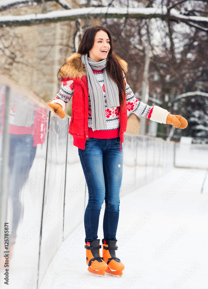 Young and pretty girl skating on an outdoor ice rink