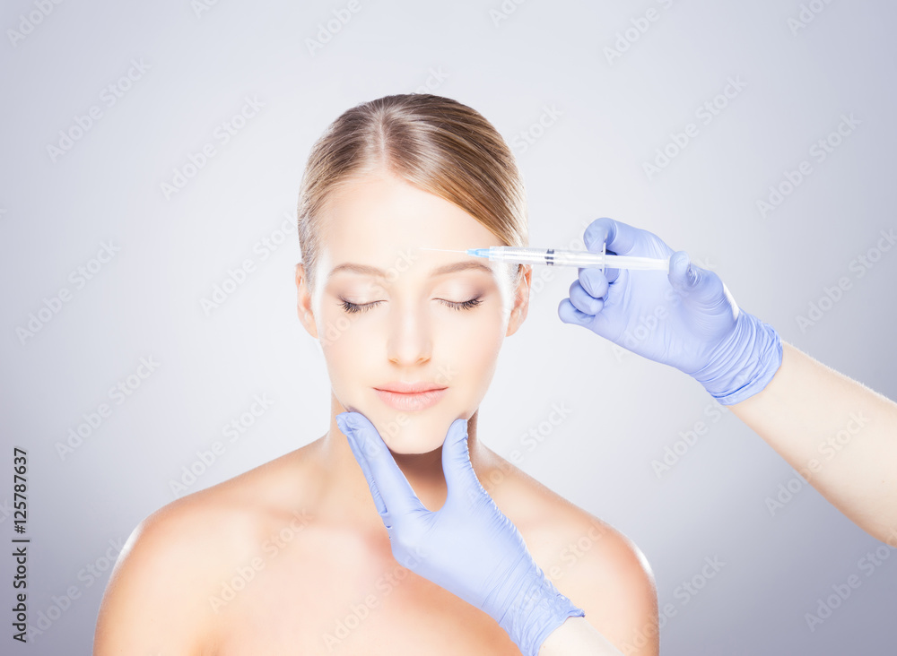 Young blond woman on a face injection procedure Young blond woman on a face injection procedure
