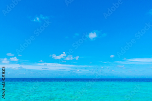 White clouds with blue sky over calm sea in tropical Maldives i