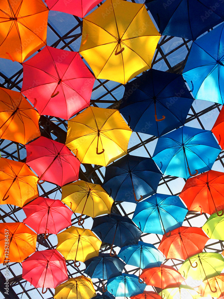 Street decorated with multicolored umbrellas in sunny day