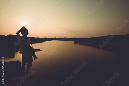 silhouette Man standing on the river