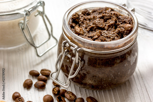 homemade coffe scrub in glass jar on wooden background